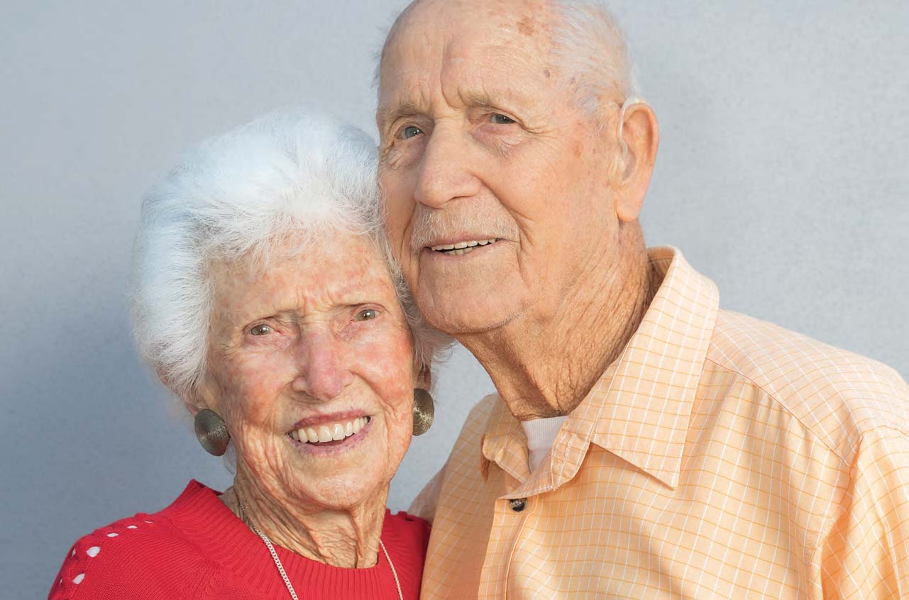 Elderly couple Marge and John smiling next to eachother