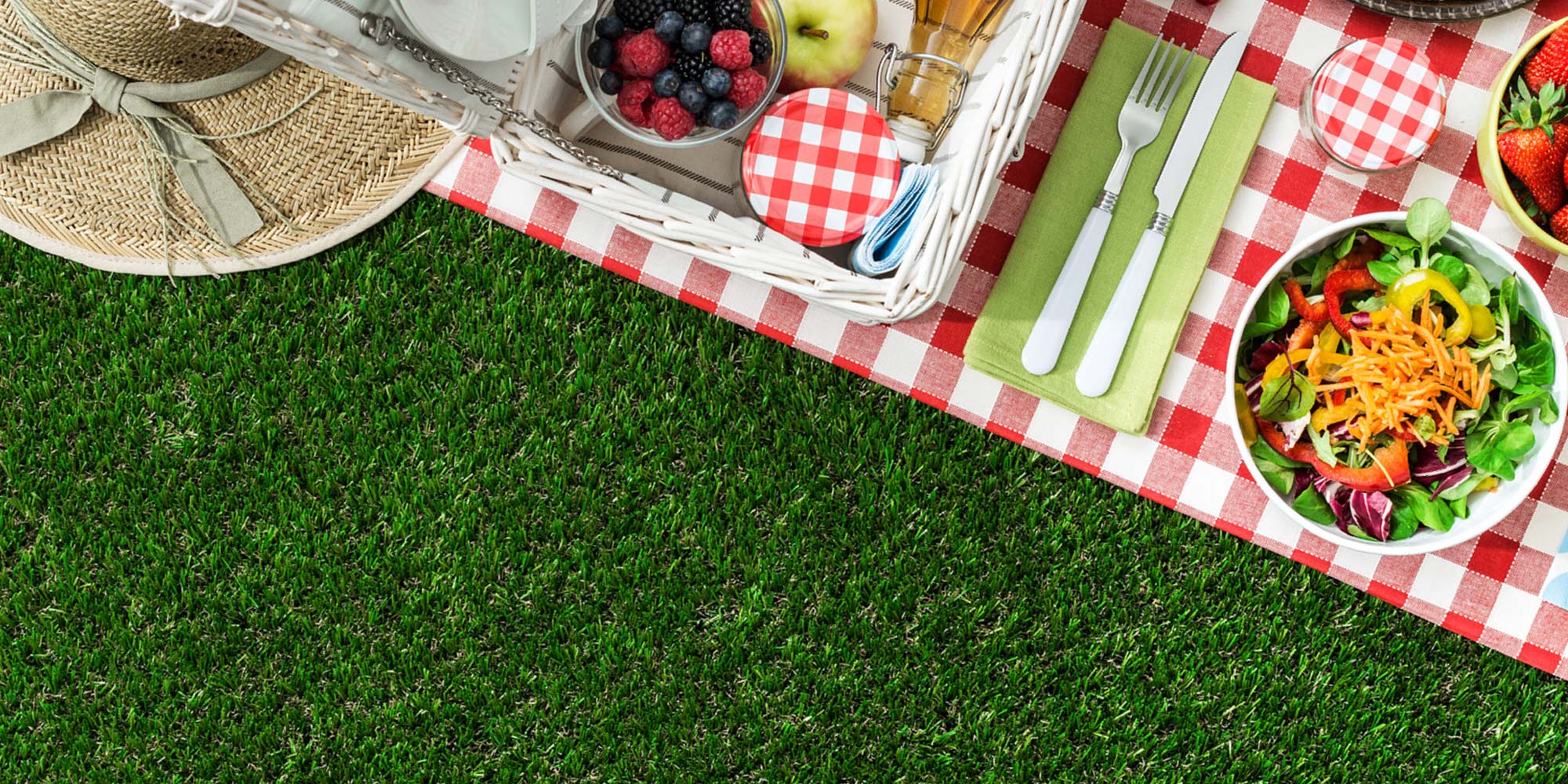 A picnic matt with food laid out on the grass