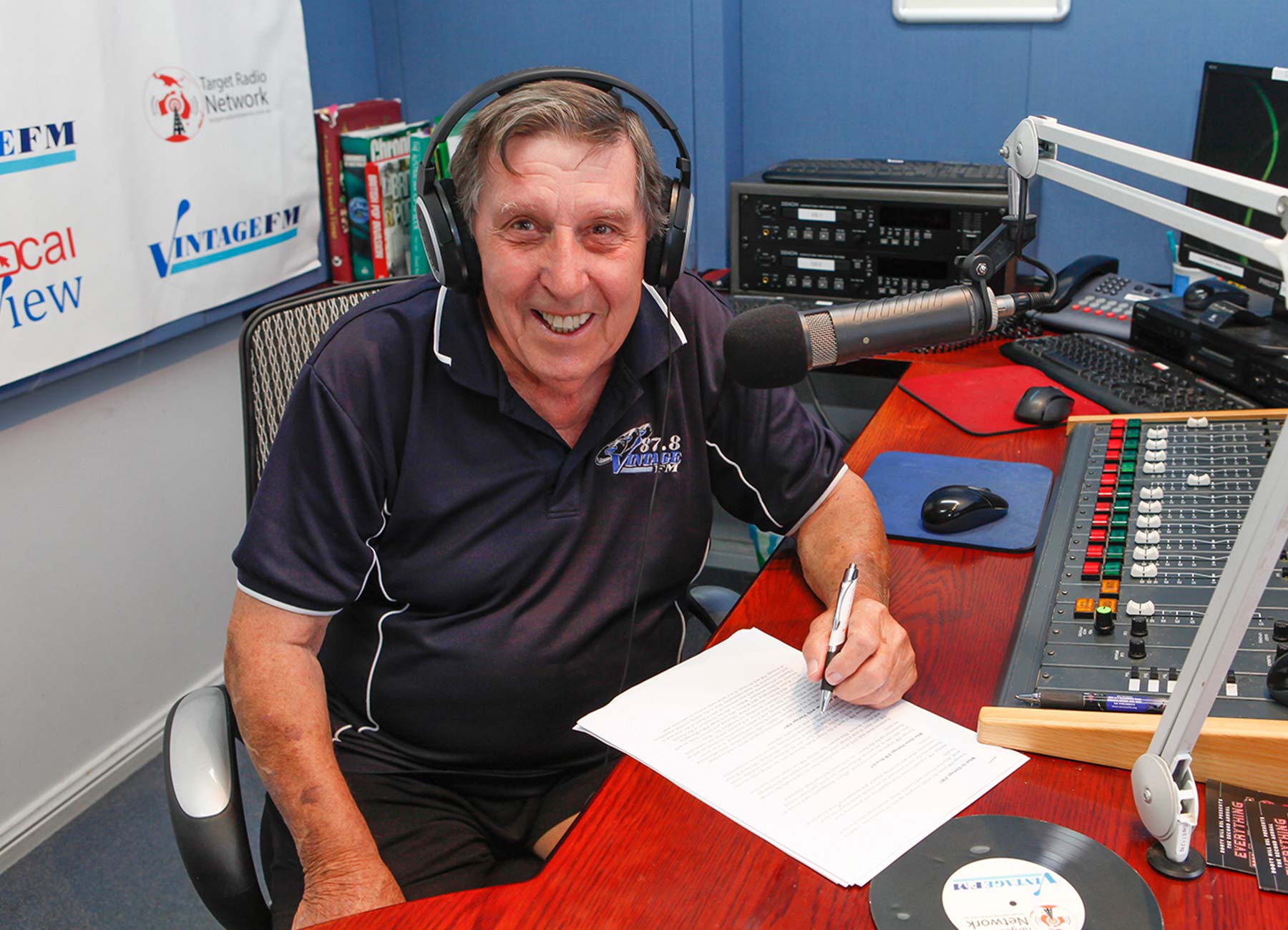 Kincare Customer Graham wearing headphones and sitting in the radio studio.