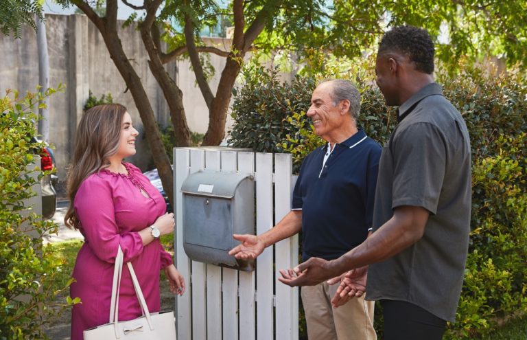 Kincare worker, elderly man and young woman talking to eachother in the front gate