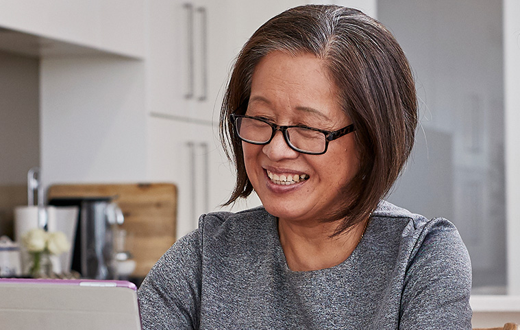 elderly woman smiling to her ipad