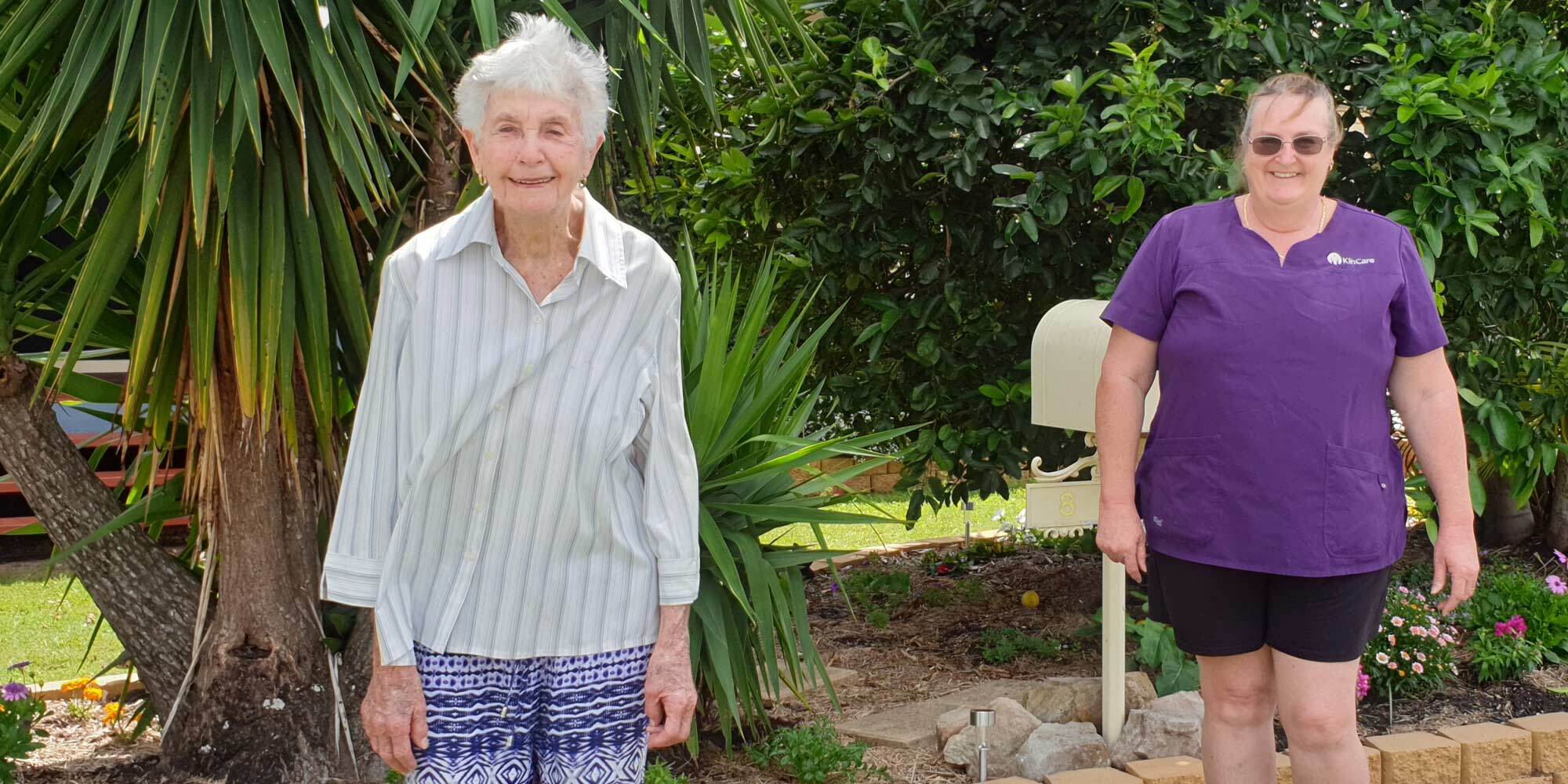 Kincare customer joan smiling as she returns back home with kincare worker